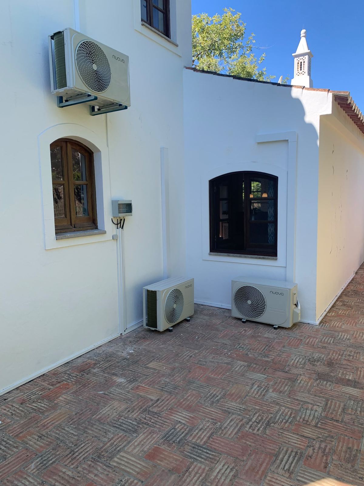 Whitewashed villa with three outdoor units