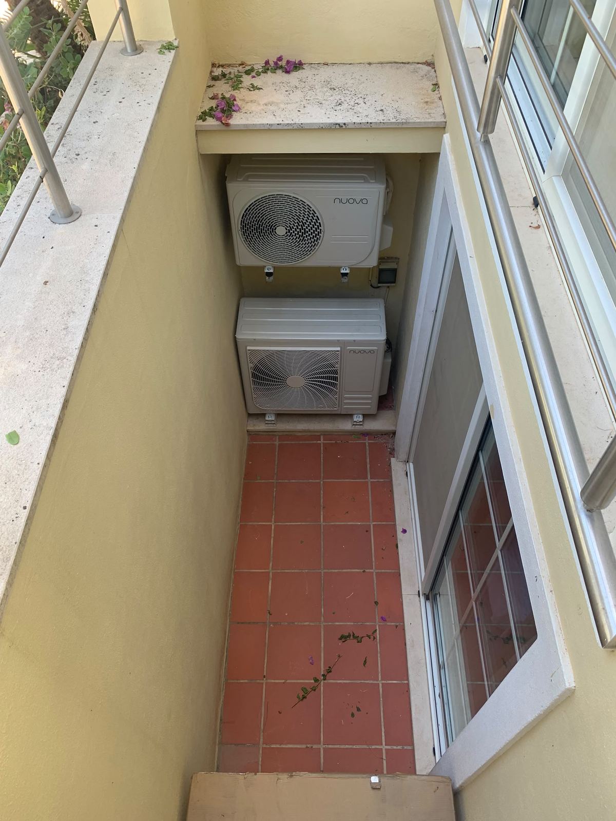 Stacked outdoor units in a narrow terrace