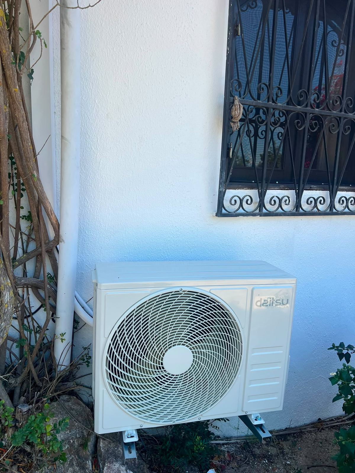 Daitsu outdoor unit on wall brackets